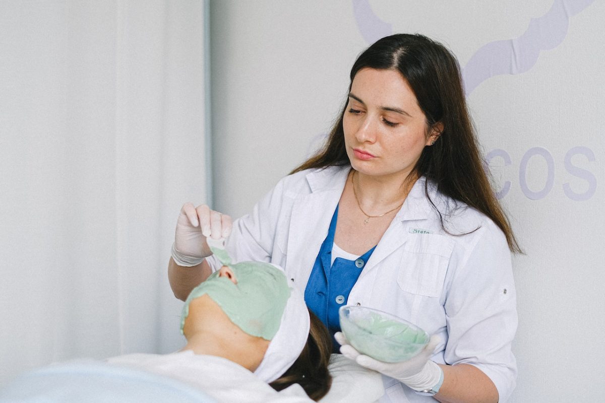 person making a mask for woman