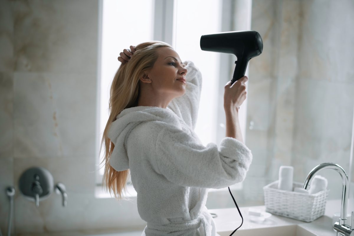 woman using hair dryer