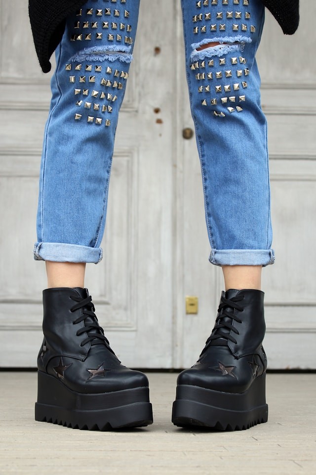 person-in-blue-denim-distressed-jeans-and-black-platform-boots