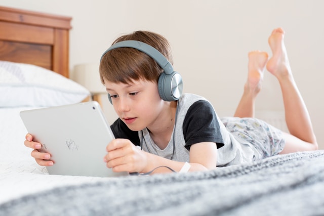 boy-in-black-shirt-using-white-laptop-computer